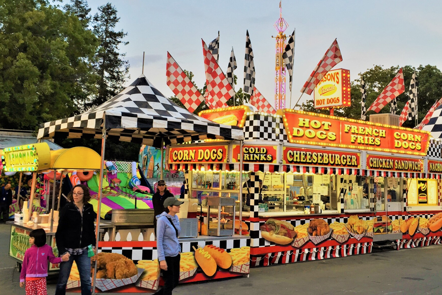Family enjoying fair food together.